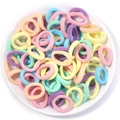 Macro view of assorted pastel high-elastic hair ties in a white ceramic dish - 2cm Diameter / Spring Colors