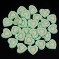 Detailed macro shot of stacked green and yellow resin heart charms for DIY crafts - Green