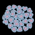 Macro view of blue and pink resin heart flatback charms for DIY crafts and accessories - Blue
