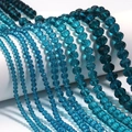 Macro detail of faceted crystal abacus beads in deep teal for DIY jewelry making - Peacock Blue