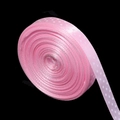 Close-up of pink polka dot polyester ribbon roll with white dots on a dark background - 1cm Wide 20 Yards/Roll / Pink