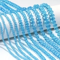 Macro view of light blue faceted crystal beads in various sizes for DIY jewelry making - Lake Blue