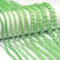 Macro view of multi-sized faceted light green crystal abacus beads for DIY jewelry making - Green