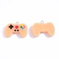 Pink resin game controller pendant with silver ring and functional button details - Orange