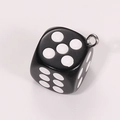 Close-up of a black acrylic dice charm with white pips and a silver metal ring - Solid Black