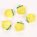 Close-up of five yellow resin peach pendants with glitter effect and green leaves - Transparent Yellow