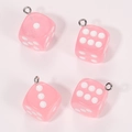 Close-up of four pink translucent acrylic dice charms with silver rings for DIY crafts - Pink And Transparent