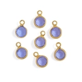 Detailed macro view of seven round lavender faceted glass charms with gold copper plating - Copper-Purple