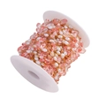 Detail view of DIY jewelry chain with pink stones and pearls on white plastic spool - Gold Plated Pink (1m)