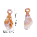Detail view of 2.4cm orange acrylic conch shell pendant for ocean-themed DIY jewelry - White Orange Mixed Sea Snail (A6-004) / 24x10mm
