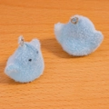 Close-up of soft light blue flocked bird charms with silver metal rings for DIY jewelry - Blue