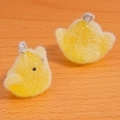 Macro detail of cute yellow flocked duckling charms with soft texture and metal rings - Yellow