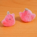Macro shot of fluffy pink flocking chick pendants with metal loops for DIY crafts - Red