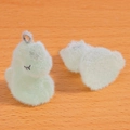Gros plan de deux pendentifs dinosaures floqués vert clair avec texture douce et anneaux - Vert clair