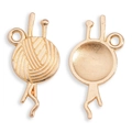 Detailed macro view of gold-tone yarn ball pendant charms with knitting needle accents - KC Gold