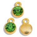 Macro shot of gold-plated birthstone pendants with green faceted crystals and textured back - Green Gold Base
