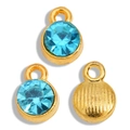 Macro detail of gold alloy pendants with light blue faceted crystals and striped backs - Gold Tone Lake Blue