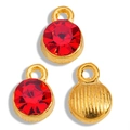 Macro detail of red birthstone alloy pendants with gold plating and ribbed back textures - Gold Base Bright Red