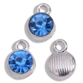 Macro shot of silver alloy pendants with round sapphire blue rhinestones and textured back - Antique Silver Base Blue