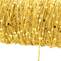 Macro view of gold copper chain with flat circular sequins for DIY jewelry making - Gold