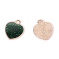 Detail of heart pendants showing green glitter enamel front and golden textured metal back - A4-485-heart-green/16*14mm/1.14g