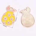 Detail view of colorful Easter bunny egg charms showing yellow enamel and gold back - Yellow Small Flower Egg Rabbit Style (A5-089)