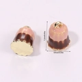 Macro view of 3D miniature Canelé pendant with dimension labels 1.2cm height and 0.9cm width - Chocolate Cake Pink (A5-079)