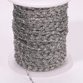 Close-up of bright silver sun flower lip chain roll with detailed textured metal links - Steel