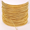 Macro shot of gold-plated 304 stainless steel ball chain wrapped on white spool - Fine Style / 18K Gold