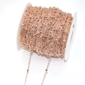 Detailed view of rose gold beaded chain on white spool for DIY jewelry making - 245SF/3.5cm Interval / Rose Gold