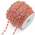 Detail of red evil eye beads on a golden chain roll for DIY jewelry making - Red Eye KC Gold Chain