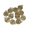 Macro detail of retro bronze alloy zodiac pendants with engraved constellation names - Aries / Antique Bronze