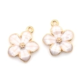 Detail of pink pearlescent cherry blossom charms with gold plating for jewelry DIY - White