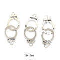 Macro shot of vintage silver handcuffs charms with freedom engraving measuring 24 by 15mm - Large Handcuff Style (24*15mm)