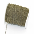 Detailed macro view of retro bronze beaded satellite chain wound on a white plastic spool - 1.45mm / Antique Bronze
