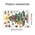 Afmetingen van de kerstmuursticker 60cm x 40cm met feestelijke boom en peperkoekmannetje - 40x60cm