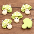 Five light green resin mushroom charms with cute smiley faces and silver metal rings - Green