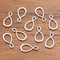 Set of 10 silver alloy twisted infinity shape connectors for DIY jewelry making - 1 Piece / Antique Silver