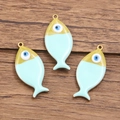 Three fish-shaped charms with blue evil eye design in gold plated stainless steel - 1 Piece / Light Blue