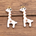 Gold plated stainless steel giraffe charm with white enamel and brown heart pattern - White Giraffe