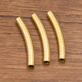 Three golden stainless steel curved tube beads with V-shaped engraving for DIY jewelry - 5x40mm / Gold