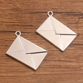 Antique silver envelope charms for DIY jewelry making on a wooden background - Antique Silver