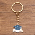 Graduation keychain with blue cap on white book charm and golden metal ring - Style 2 (22X24mm)