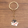 Golden alloy graduation keychain featuring academic cap, books, and diploma scroll charm - Style 5 (21X23mm)