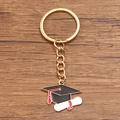 Graduation keychain featuring a black mortarboard and white diploma on wood background - Style 6 (23X28mm)