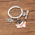 Detailed close-up of 2026 graduation keychain with black mortarboard and scroll charms - Style 5 (21X23mm)