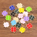 Colorful four-leaf clover alloy charms with gold frames on dark wood background - 1 Piece/Pack / Random Mixed Colors