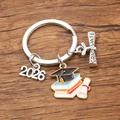 Detail of 2026 graduation keychain with colorful enamel cap and scroll on wood - Style 8 (21X25mm)