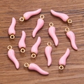 Pink enamel chili pepper charm with gold ring for DIY jewelry making on wood background - Pink