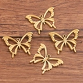 Juego de cuatro colgantes de mariposa dorados calados para hacer joyas de bricolaje - Estilo de Mariposa Calada Dorada